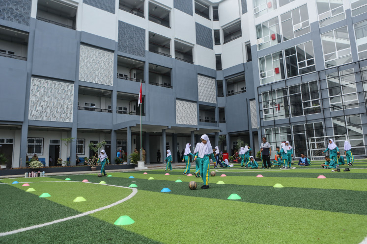 Students attend classes at state elementary school SD Pekayon 05 and state junior high school SMP 91 in Jakarta on Oct. 12, 2026. 