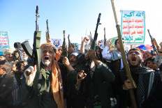 Supporters of the Houthi authorities brandish their weapons on Friday during a protest against Saudi intervention in Yemen, in Sanaa. The Houthis, who are fighting the Saudi-backed, internationally recognized government, seized the coastline alongside crucial trade route during a lightning offensive last month, extending their control over all of Yemen's Red Sea coast. Yemeni government forces have been attempting for several days to retake coastal territory captured by the pro-Iranian fighters. 