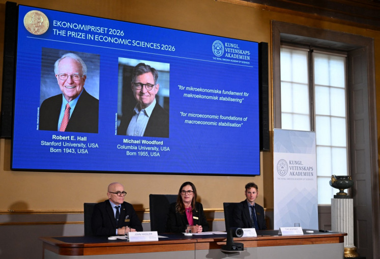 Secretary General of the Royal Swedish Academy of Sciences Ellen Moons (center), Chair of the Prize Committee John Hassler (left) and Member of the Prize Committee and expert Timo Boppart announce US economists Robert E Hall and Michael Woodford as the winners of the 2026 Sveriges Riksbank Prize in Economic Sciences in Memory of Alfred Nobel at the Royal Swedish Academy of Sciences in Stockholm on October 12, 2026.