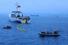 Philippine Coast Guard's patrol vessel BRP Gabriela Silang OPV-8301 deploys its oil boom on Oct. 11 during oil spill response Marpolex 2026 in Bitung, North Sulawesi. The exercise involved 21 vessels from Indonesia, the Philippine and Japan. 