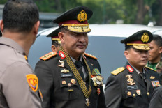 Newly appointed National Police chief Gen. Suyudi Ario Seto (center) arrives for his inauguration on Oct. 1 at the State Palace in Jakarta.
