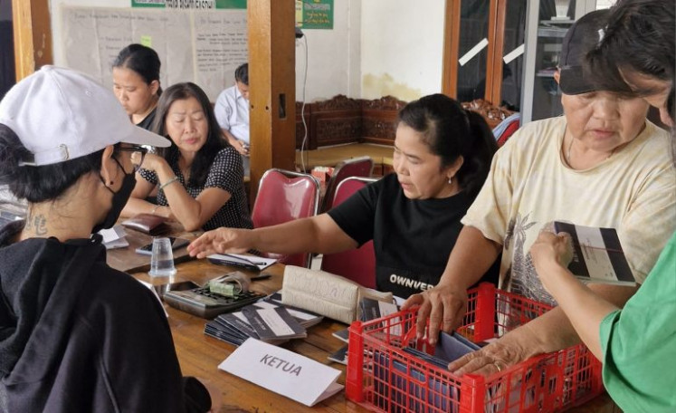 Savings in action: Chen Fie (second right) oversees savings and loan transactions at the Lampion Merah Abadi Women&rsquo;s Resource Development Cooperative in Kosambi, Tangerang, Banten, on Aug. 20, 2026.
