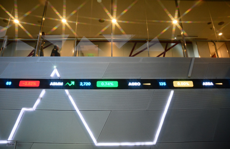 An electronic board displays stock prices at the Indonesia Stock Exchange (IDX) building in South Jakarta on Oct. 14, 2026.
