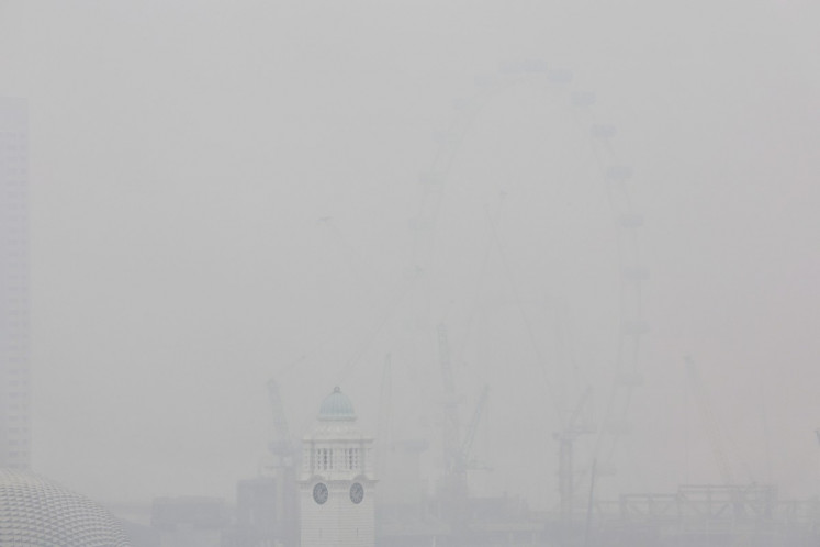 This picture provided by The Straits Times taken and received on October 14, 2026 shows the city shrouded with haze in Singapore. Air pollution in western Singapore hit the country's &ldquo;very high&ldquo; band on October 14, the environment agency said, as haze from Indonesia forest fires causes a regional crisis. 