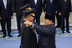 President Prabowo Subianto (right) attaches rank insignia on Oct. 1, 2026, to the uniform of newly appointed National Police Chief Suyudi Ario Seto (left) during his inauguration at the State Palace in Central Jakarta. 