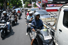 Motorcyclists queue to refuel at a gas station in Denpasar amid a fuel supply shortage in Bali on Oct. 14, 2026. 