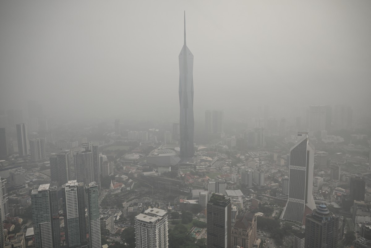 Buildings are shrouded in haze caused by fires in Indonesia, in Kuala Lumpur on October 16, 2026. Toxic haze has covered parts of Indonesia, Malaysia and Singapore for weeks as Jakarta struggles to contain fires that have scorched large tracts of Borneo and Sumatra, with the smoke drifting across the region. 