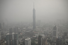 Buildings are shrouded in haze caused by fires in Indonesia, in Kuala Lumpur on October 16, 2026. Toxic haze has covered parts of Indonesia, Malaysia and Singapore for weeks as Jakarta struggles to contain fires that have scorched large tracts of Borneo and Sumatra, with the smoke drifting across the region. 