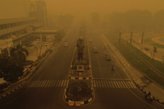 Thick smoke and haze from forest and land fires covers Palangkaraya, Central Kalimantan, on Oct. 15, 2026. Toxic haze has covered parts of Indonesia, Malaysia and Singapore for weeks as Jakarta struggles to contain fires that have scorched large tracts of Kalimantan and Sumatra, with the smoke drifting across the region. 
