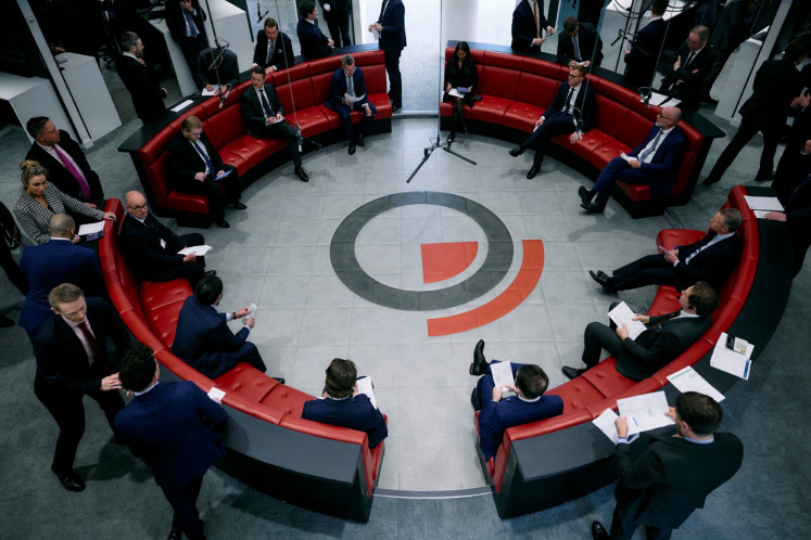 Traders, brokers and clerks gesture on March 11, 2025, on the trading floor of the open outcry pit, also known as The Ring, at the London Metal Exchange (LME) in London.