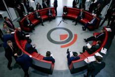 Traders, brokers and clerks gesture on March 11, 2025, on the trading floor of the open outcry pit, also known as The Ring, at the London Metal Exchange (LME) in London.