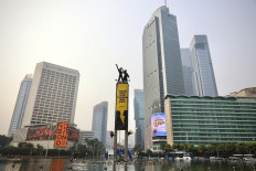 Greenpeace Indonesia activists unfurled two giant banners from the top of the Tugu Selamat Datang monumnet at the Hotel Indonesia traffic circle in Central Jakarta, on Oct. 20, 2026.