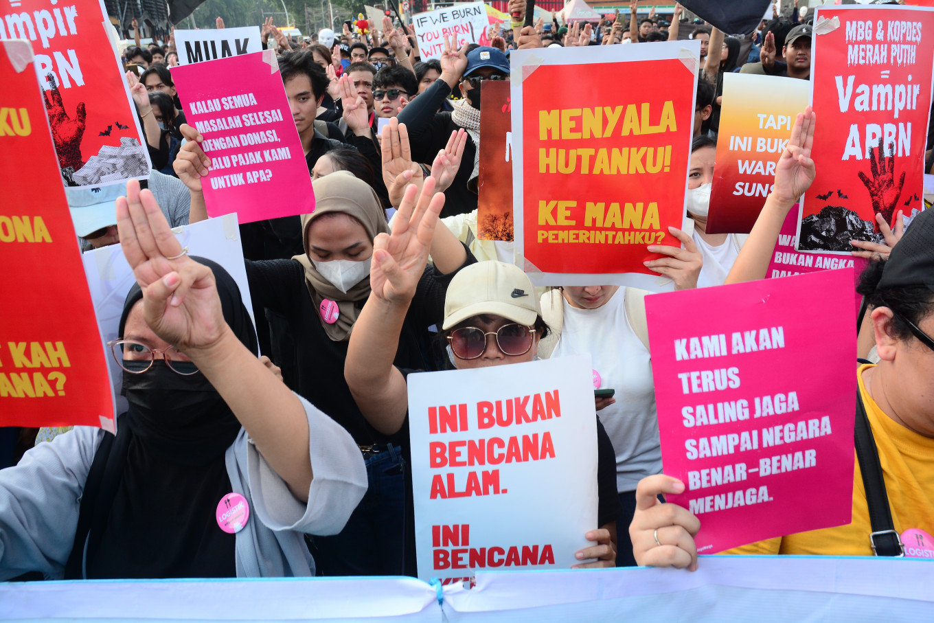 Demonstrators hold placards and raise three fingers in a salute symbolizing freedom, solidarity and equality during a protest in Jakarta on Oct. 20, 2026. The protesters called for an end to forest and land fires and demanded the eradication of corruption, collusion and nepotism as they marked the second anniversary of President Prabowo Subianto and Vice President Gibran Rakabuming Raka&rsquo;s administration.