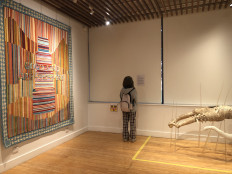 Reading the work: A visitor reads on Aug. 28, 2026, an artwork caption in the Tapestry of Encounters: Contemporary Indonesian Art at Western Sydney University in Australia.