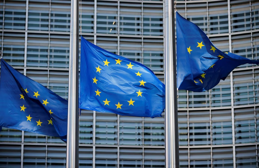 European Union flags fly at half-mast outside the European Commission headquarters in Brussels on March 1, 2023, to honor the victims of the Greece train collision on Feb. 28.