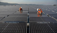 Final tweaks: Technicians check panels on Sept. 29, 2023, at the Cirata floating solar photovoltaic plant, located at the Cirata Reservoir in Purwakarta, West Java. 