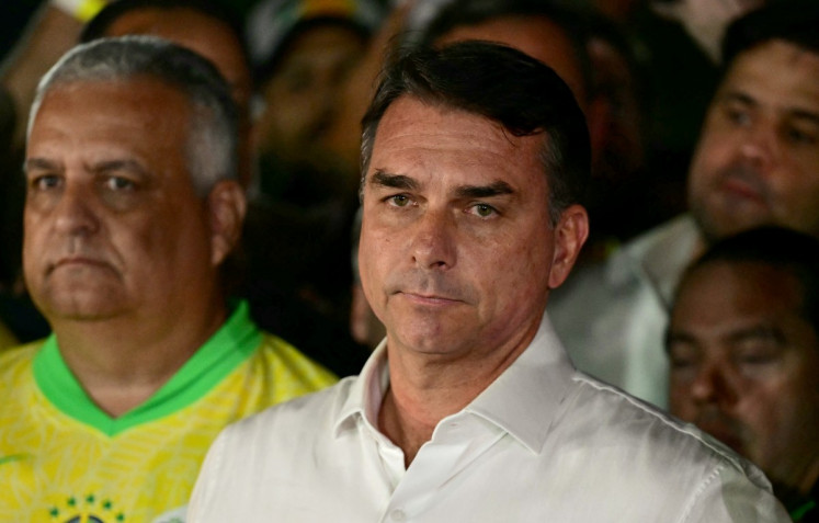 Brazil's right-wing senator and presidential candidate for the Liberal Party (PL) Flavio Bolsonaro reacts after knowing the first results in the presidential runoff election, in Brasilia, on October 25, 2026. Brazil's President and re-election candidate for the Workers' Party (PT) Luiz Inacio Lula da Silva pulled off a dramatic comeback on October 25, 2026, as he clinched election victory against right-wing senator Flavio Bolsonaro, who trounced him in the first round.