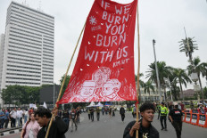 Protesters hold a large red banner reading &ldquo;If we burn, you burn with us&ldquo; during a protest against economic hardship, graft and the government's handling of devastating wildfires causing toxic haze that has sickened thousands in Jakarta on Oct. 28, 2026.