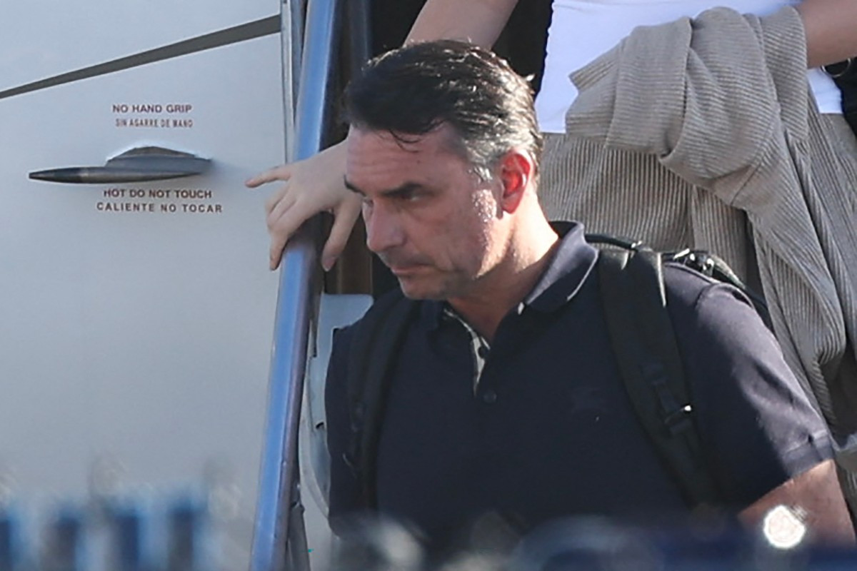 Brazil's defeated right-wing presidential candidate Flavio Bolsonaro steps off a private plane after arriving in Florida, the United States, on October 28, 2026, despite a court order banning him from leaving his country. His plane touched down at Opa-Locka Executive Airport outside Miami after flying from Argentina with a stopover in Ecuador, as speculation had swirled for days over his whereabouts.